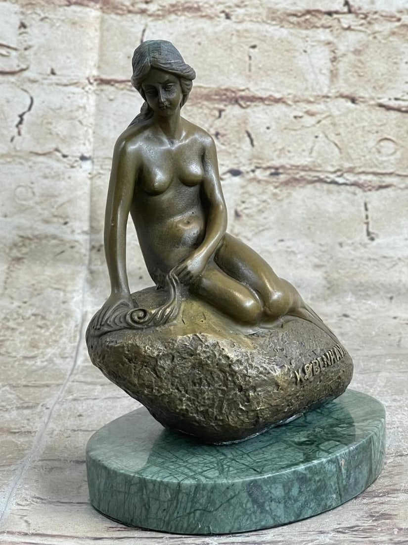 The Little Mermaid Bronze Sculpture on Marble Base - 7" x 5": The Little Mermaid Bronze Sculpture on Marble Base - 7" x 5" This bronze sculpture captures the serene grace of the Little Mermaid with delicate features and a gentle, downward gaze. Crafted u