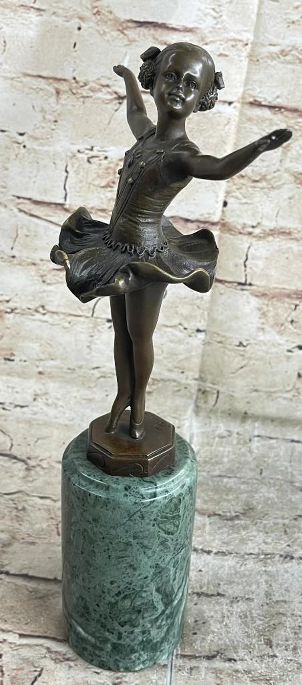 Vienna Ballerina Bronze Reproduction Sculpture: Vienna Ballerina Bronze Reproduction Sculpture A young girl dances for a loving crowd. She raises her ballerina arms out to her sides and twirls on the tips of her tiny toes. Her tutu frills billow ar