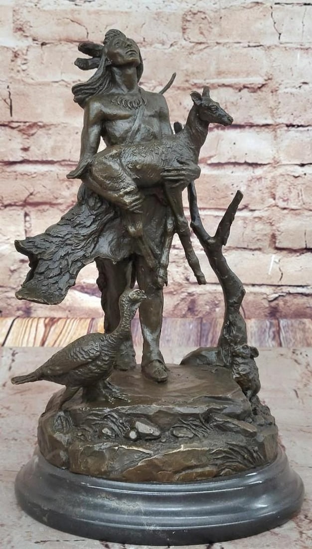 Spirit of the Forest Bronze Sculpture: Spirit of the Forest Bronze Sculpture This beautifully detailed bronze sculpture bearing the signature of artist Moreau depicts an Indigenous man cradling a baby deer in his arms, a gentle symbol of h