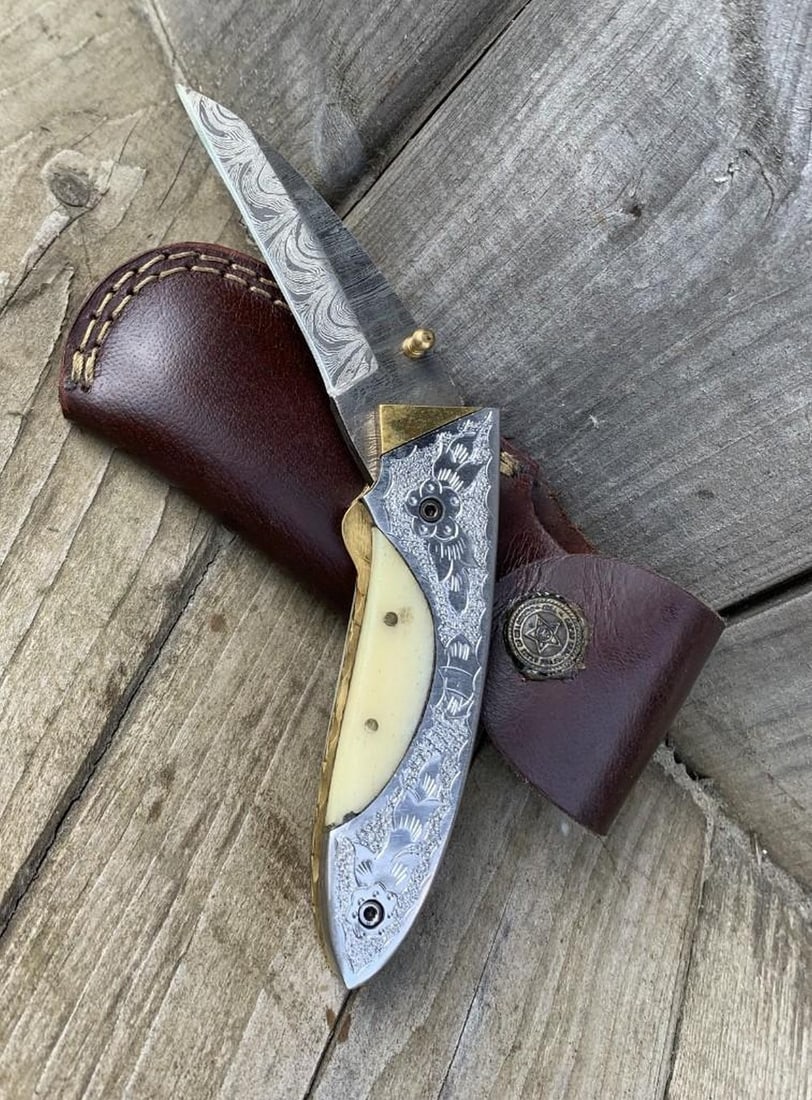 Last Anguish Folding Damascus Knife: Custom Handmade Damascus Steel Hunting, Camping & Folding Knife Handle Engraved on steel and camel bone. Damascus Steel Blade with 256 Layers on it. HARDNESS 56-60 H R C VERY HIGH QUALITY GENUINE