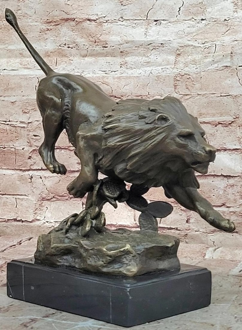 Running Lion Bronze Statue - 13" x 16": Running Lion Bronze Statue - 13" x 16" This bronze statue depicts a running lion in a dynamic pose, capturing strength, courage, and motion. The figure emphasizes muscular form, flowing mane, 