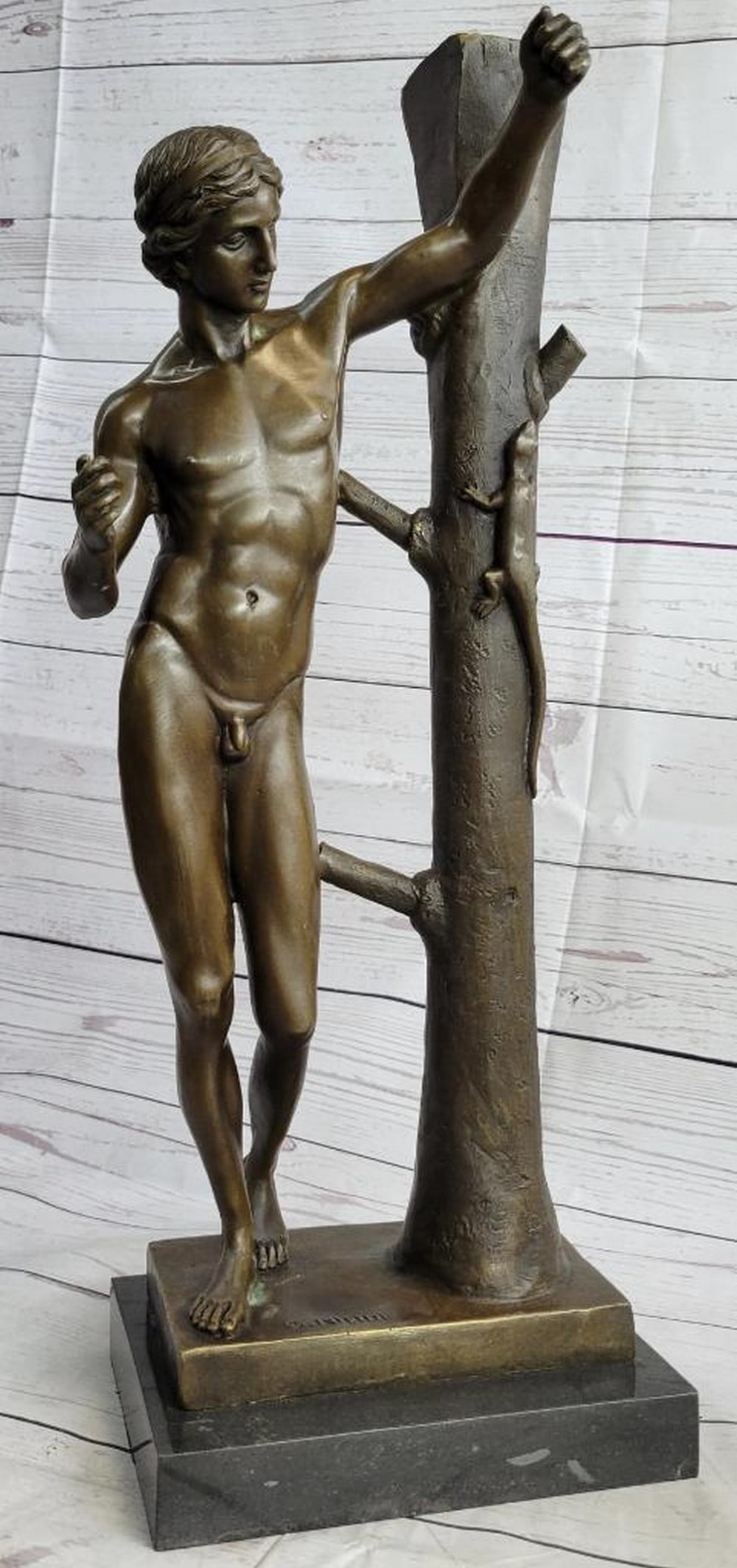 Nisini Inspired Nude Man Leaning Against Tree Bronze Sculpture - 21" x 9": Nisini Inspired Nude Man Leaning Against Tree Bronze Sculpture - 21" x 9" Immerse yourself in the serene beauty of nature with this captivating bronze sculpture. In a peaceful wooded garden, a