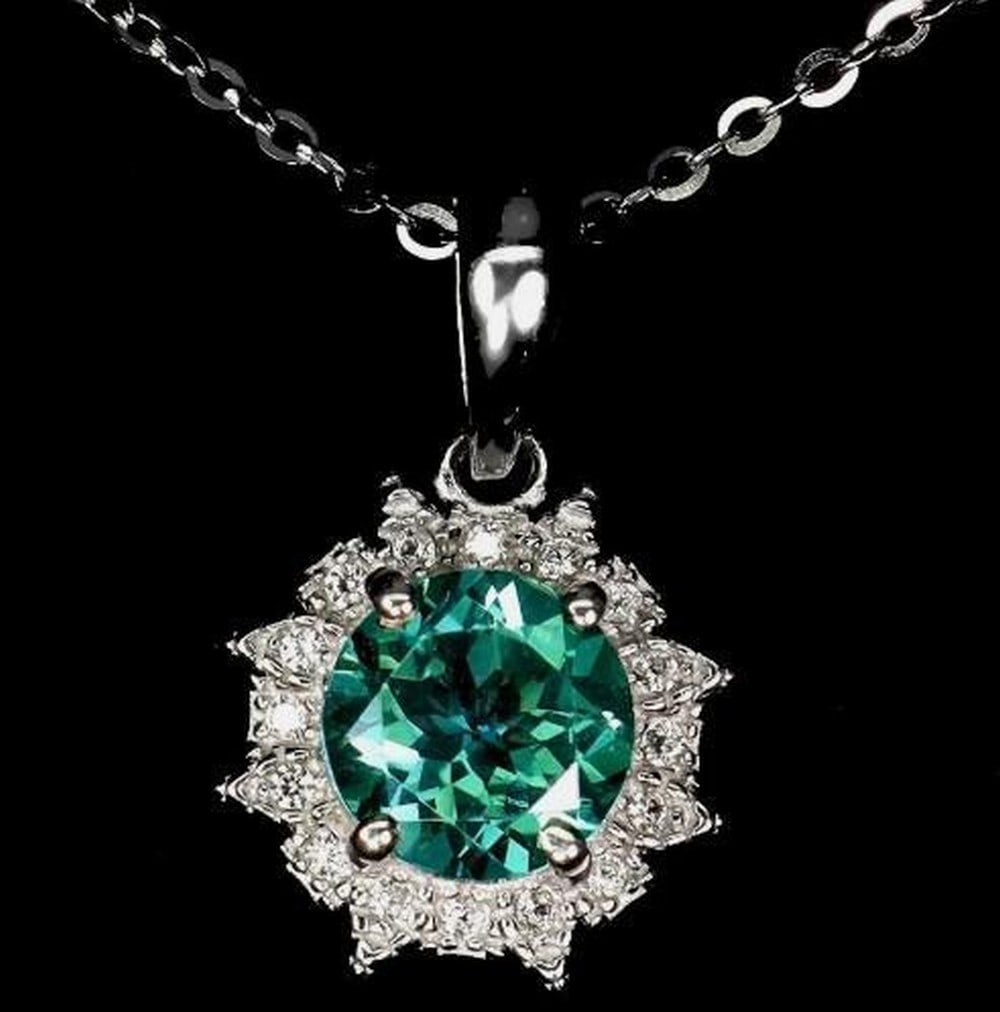 Elegant Green Topaz Pendant Necklace: Elegant Green Topaz Pendant Necklace This elegant 925 sterling silver necklace features a 7mm round green topaz gemstone, celebrated for its vibrant green hue and sparkling clarity. Set in a polished