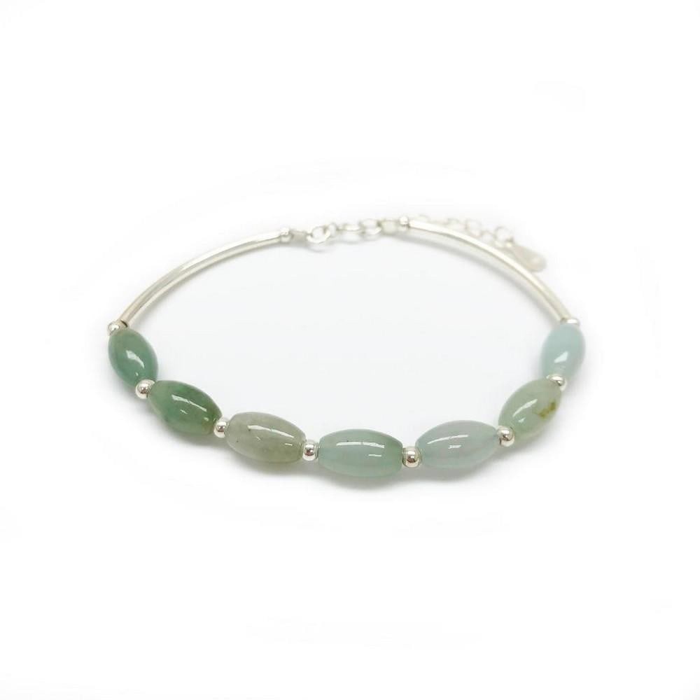 Sterling Silver Natural Jade Oval Bangle: Sterling Silver Natural Jade Oval Bangle This elegant bangle features oval-cut green jade stones set in polished sterling silver. The natural jade showcases beautiful light green tones, creating a
