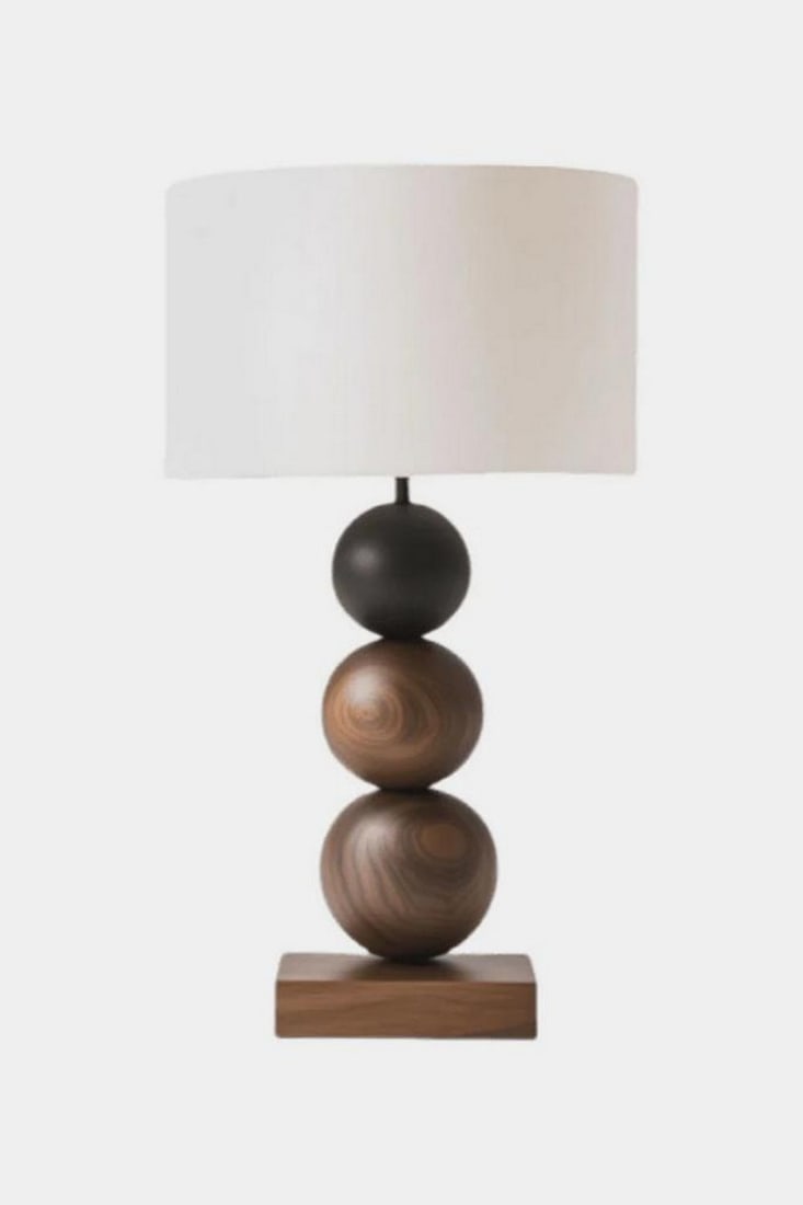 Contemporary Balanced Wood Table Lamp: Contemporary Balanced Wood Table Lamp This table lamp features a vertically stacked base composed of three rounded wooden spheres in complementary natural wood tones, accented by a small matte black