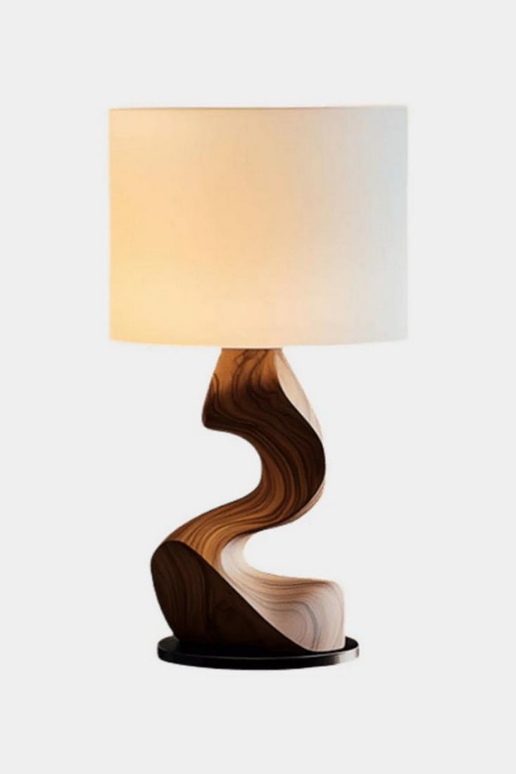 Wavy Sculptural Wood Table Lamp: Wavy Sculptural Wood Table Lamp Soft and sophisticated, this handcrafted table lamp features a flowing, wave-like wooden base that evokes movement and artistry. Anchored on a sleek black platform and