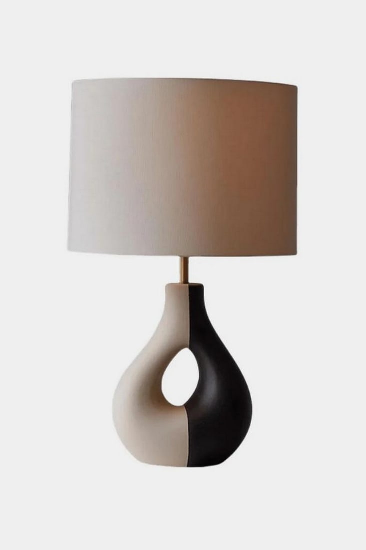 Dual-Tone Harmony Table Lamp: Dual-Tone Harmony Table Lamp Elegant and balanced, this handcrafted table lamp features a sculptural base with two smoothly curved halves - one in light beige, the other in deep brown - joined in a