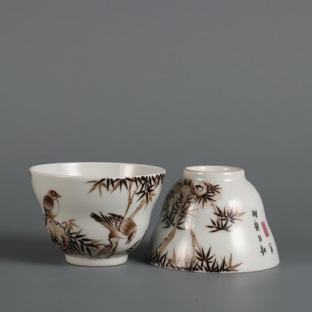 Pair of Qing Yongzheng Grisaille 'Bamboo and Sparrow' Picture Cups: Pair of Qing Yongzheng Grisaille 'Bamboo and Sparrow' Picture Cups A finely crafted pair of porcelain cups from the Qing Dynasty Yongzheng period, featuring elegant grisaille paintings of bamboo and s