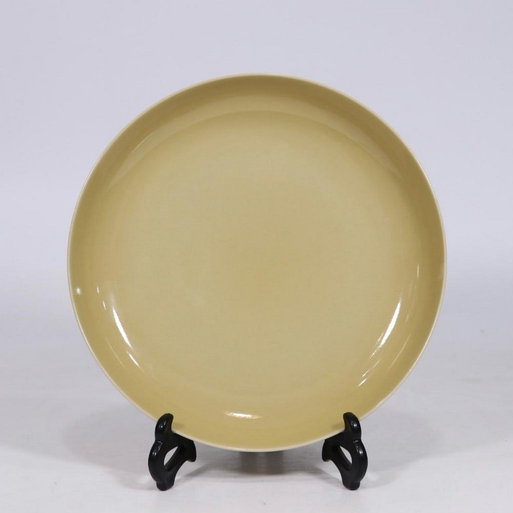 Qing Dynasty Yongzheng Delicate Yellow Glaze Plate: Qing Dynasty Yongzheng Delicate Yellow Glaze Plate A finely crafted porcelain plate from the Yongzheng period of the Qing Dynasty, finished in a soft, delicate yellow glaze. The smooth, lustrous surfa