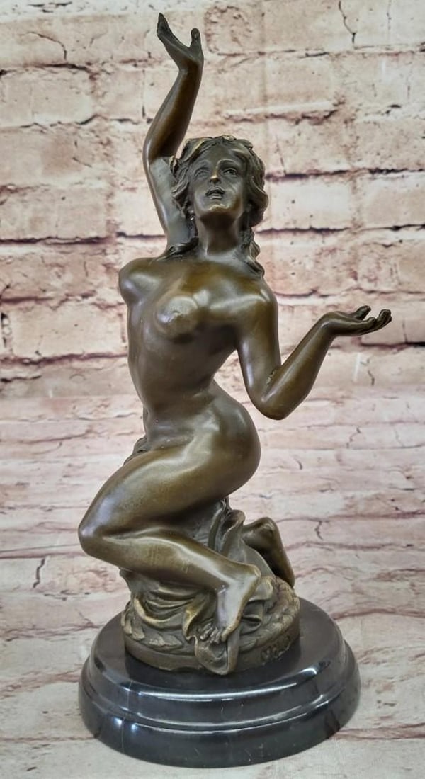 Ascendant Grace Bronze Sculpture: Ascendant Grace Bronze Sculpture Bearing the signature of artist Milo, this bronze sculpture beautifully captures a moment of vulnerability and strength. The nude woman, posed on her knees with arms r