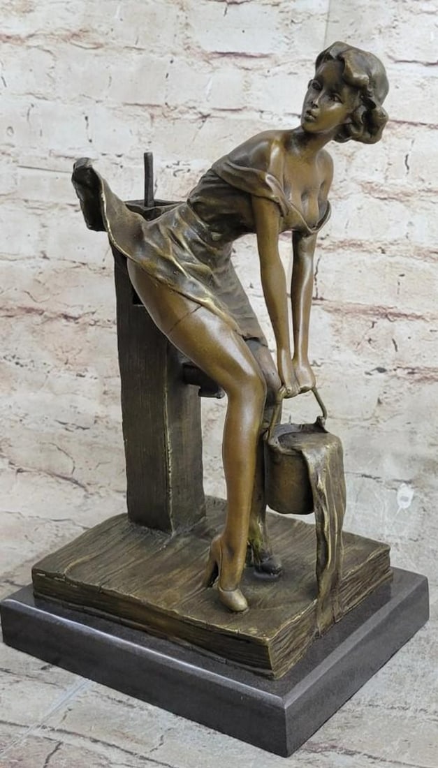 The Weight of Grace Bronze Reproduction Sculpture: The Weight of Grace Bronze Reproduction Sculpture This graceful bronze reproduction captures a tender moment of daily life, where a woman in a flowing dress bends down to collect water from a faucet, 