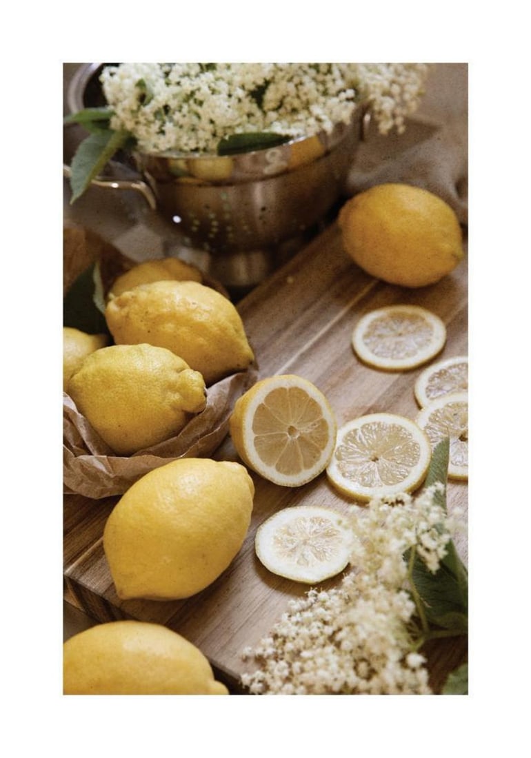 Lemons and Elderflower Poster: Lemons and Elderflower Poster A detailed poster featuring bright yellow lemons and delicate white elderflowers arranged on a rustic wooden board. The composition highlights natural textures and soft c