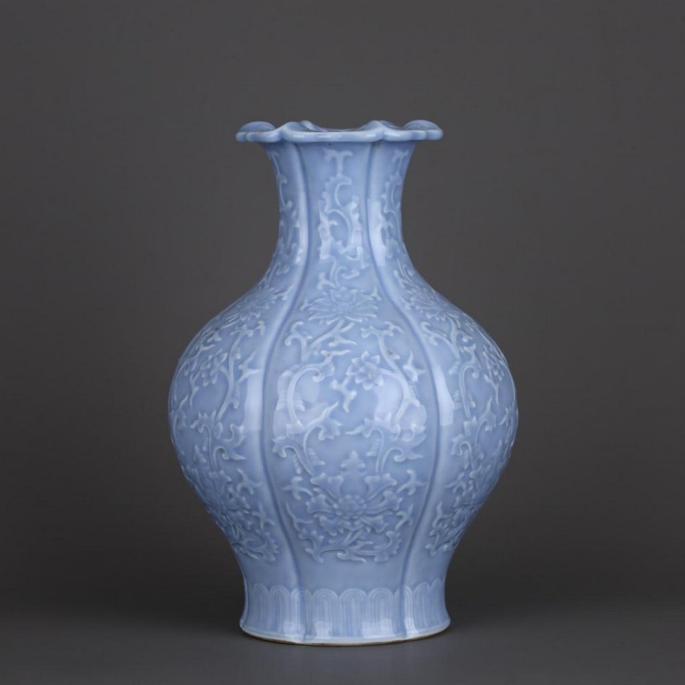 Qing Dynasty Qianlong Sky-Blue Glaze Carved Entwined Flower Pattern Melon-Edge Flower-Mouth Vase: Qing Dynasty Qianlong Sky-Blue Glaze Carved Entwined Flower Pattern Melon-Edge Flower-Mouth Vase An exquisite porcelain vase from the Qianlong period of the Qing Dynasty, finished in a soft sky-blue g
