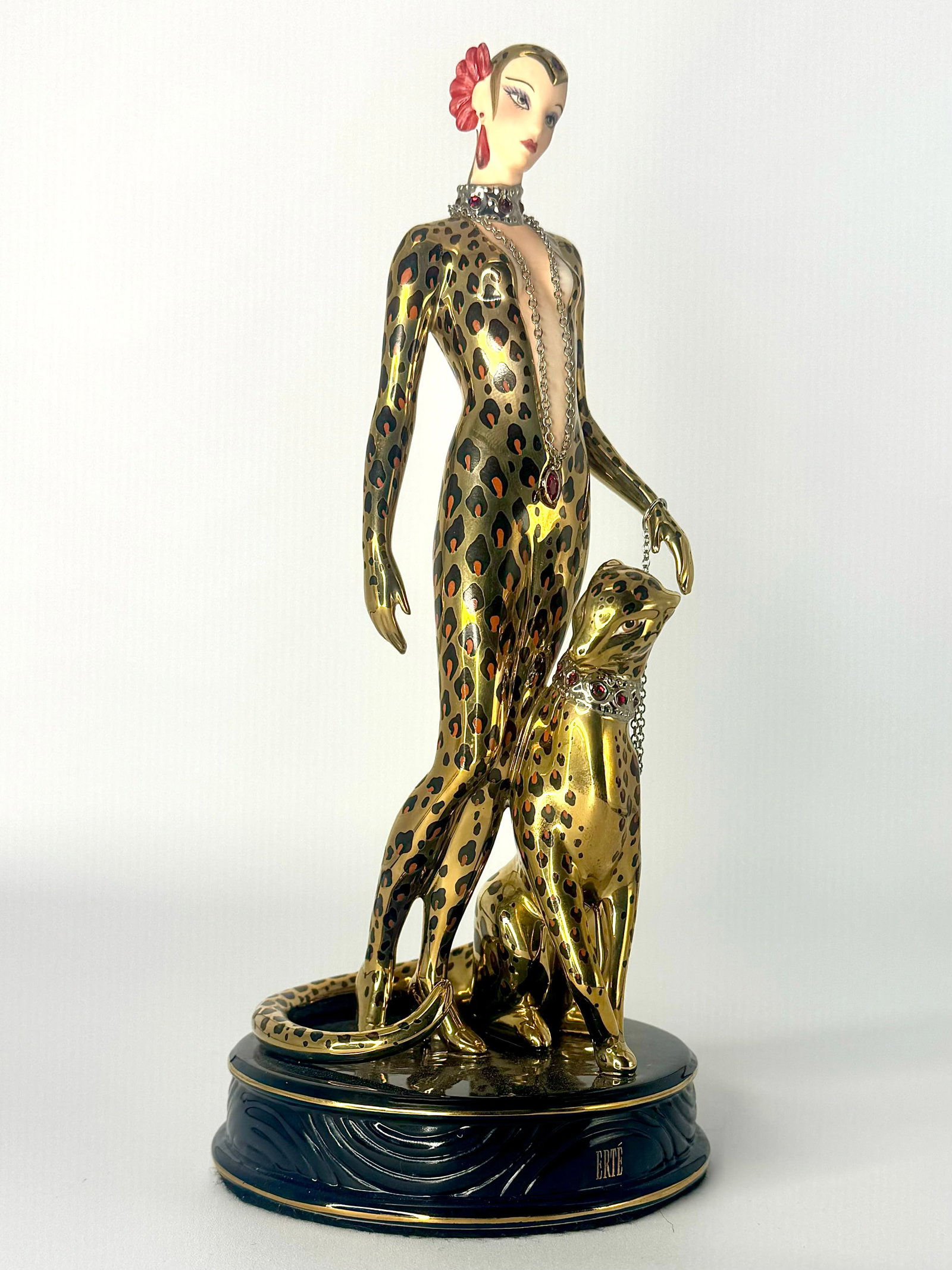Stunning ERTE Art Deco Woman with Leopard Fine Porcelain Figurine: This Figurine is in Beautiful Condition. It has No Chips, Cracks or Repairs but as seen in the photos, the bottom has some crazing. It measures approximately 9 Inches tall. It is Signed House of ERTE