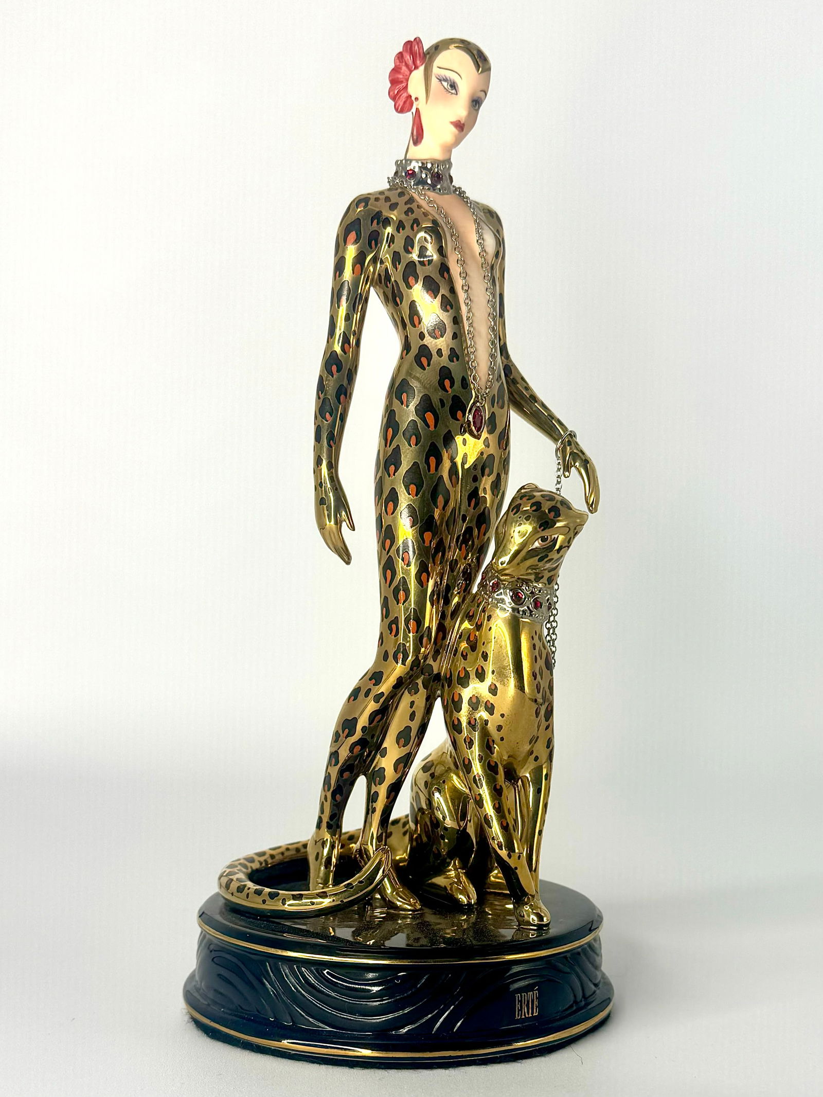 Stunning ERTE Art Deco Woman with Leopard Fine Porcelain Figurine: This Figurine is in Beautiful Condition. It has No Chips, Cracks or Repairs but as seen in the photos, the bottom has some crazing. It measures approximately 9 Inches tall. It is Signed House of ERTE