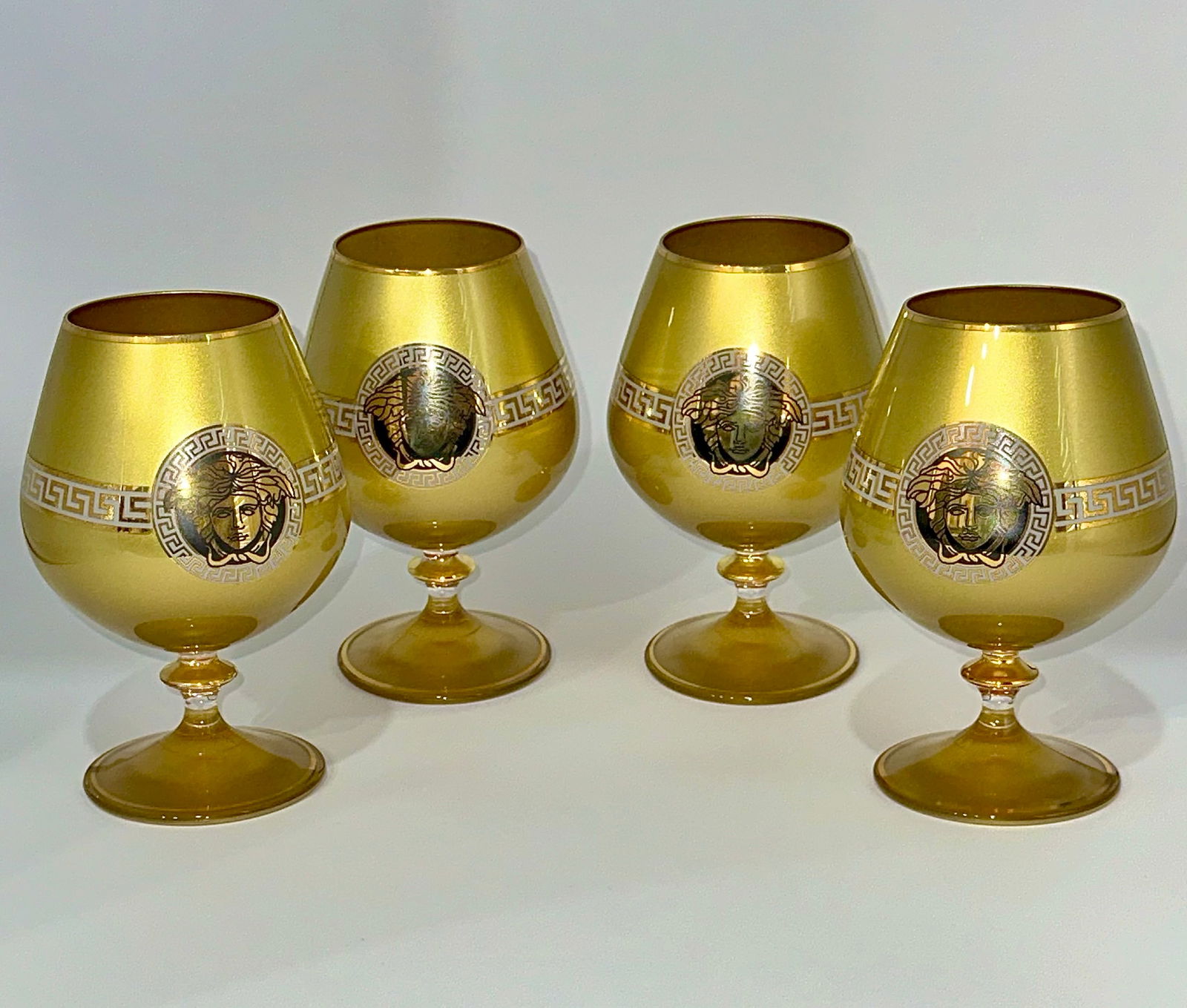 Lot of 4 Versace Medusa Gold and Platinum Crystal Brandy Goblets: These are Vintage Never Used Not Marked Versace Brandy Glasses with a Gold Platinum Finish. They are Not signed but from the research we did, we noticed that many of the items Versace put out was not