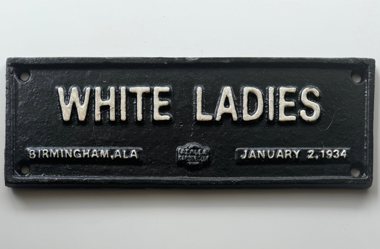 Dated 1934 Black Americana Cast Iron Segregation Sign: Approximately 8 x 3.5 – White Ladies – Although this is a dated piece we are certain it is not of the period. We do not know when this was produced. We are also aware that this symbolizes a dark p
