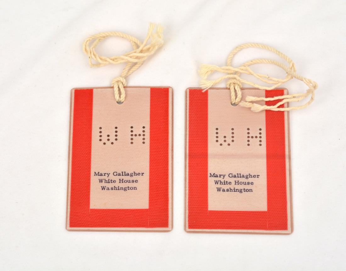 Mary B. Gallagher White House Luggage Tags: Two 4 x 2.75'' red and cream laminated White House luggage tags. These tags were commonly used by Mary Gallagher when traveling with Jacqueline Kennedy during the Kennedy administration. These items c