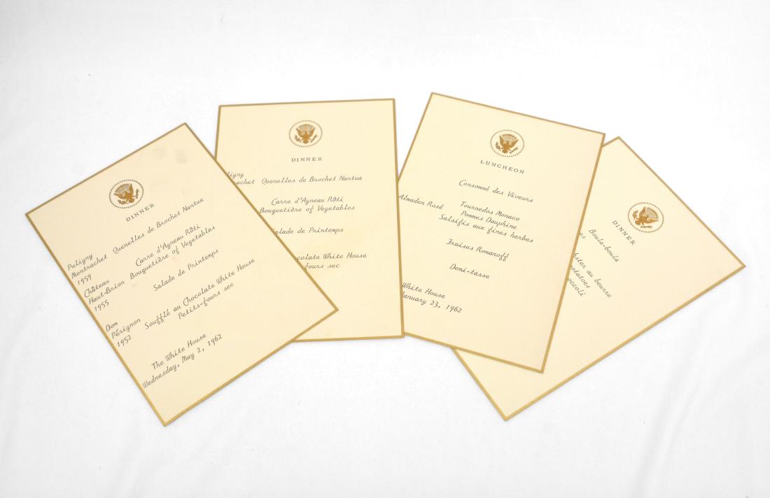 John F. Kennedy's Birthday White House Menu: Four assorted official White House 7.5 x 5'' menus on gold edged heavy weight cream paper with the Presidential Seal stamped in gold on the front. The menus detail the dates of the events as well as t