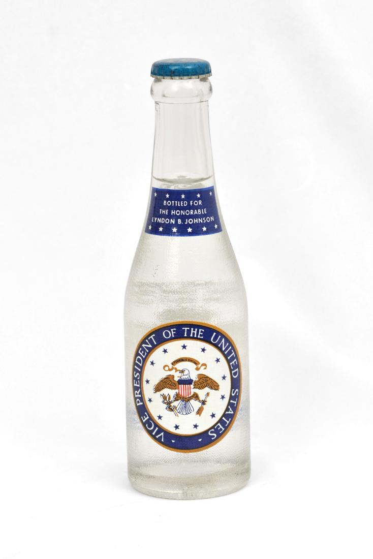 Lyndon B. Johnson Club Soda Bottle: An unopened 8'' tall Canada Dry Club Soda bottle with the "Vice President of the United States" seal and "Bottled For The Honorable Lyndon B. Johnson" on the face. These were bottled for Johnson as a