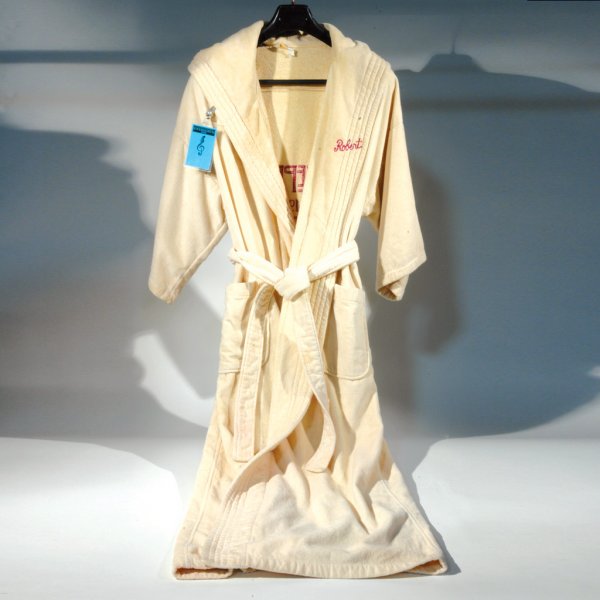 Robert Plant Bathrobe with Concert Badge: This cream colored 100% terry cloth robe, with matching belt, is embroidered on the back in maroon-colored type "Led Zeppelin The 1980s Part One" - the tour was split, with part one being the European