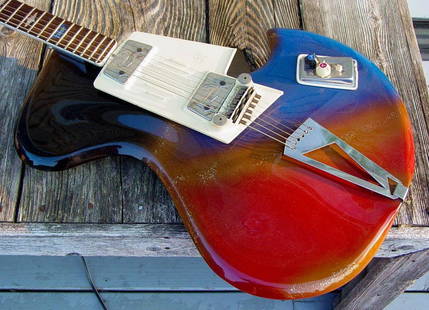 c. 1963 Wandre "Rock Oval" Guitar: c. 1963 Wandre "Rock Oval" guitar, original red, blue, and copper metallic finish, with original tweed case. With its huge scooped treble cutaway, super thin semi-hollow body, and stunning colors,