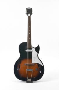 1940s Kay Archtop: A 1940's Kay electric archtop guitar, comes with its original case. Trapeze tailpiece, white fingerboard with a graphic of an easel with a "K" on it in black. Sharp florentine cutaway. A few small