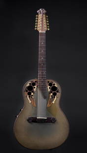John Denver's 1979 Ovation Adamas 12-string: A pale green 12-string Ovation Adamas with autumnal leaf design and unique circular sound holes. A one-of-a-kind heirloom, a fine instrument once owned and used extensively on world tours by