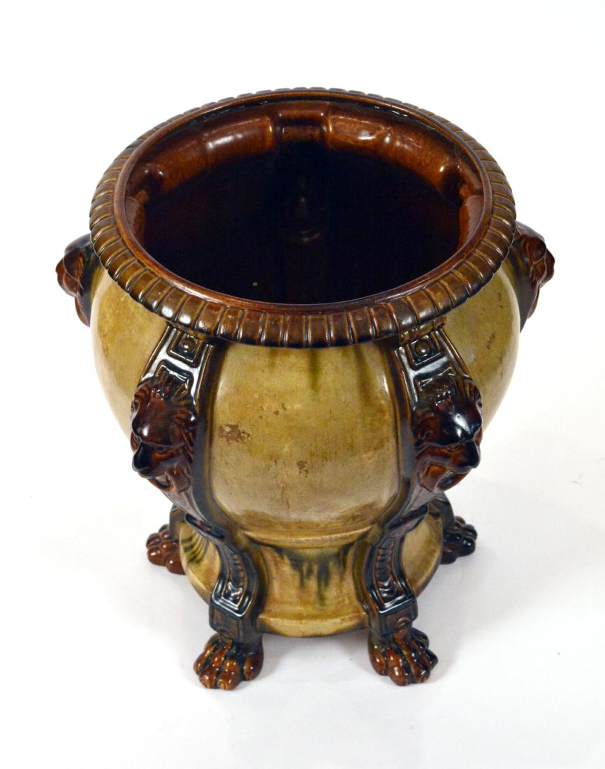 Pottery Planter with Lions Heads: 16"D. x 18"H. Guest House Entry Foyer. NO RESERVE. This lot was formerly the property of well-known real estate developer Mr. Melvin Simon and his wife, Bren Simon. It is part of the Simon's Asherwood