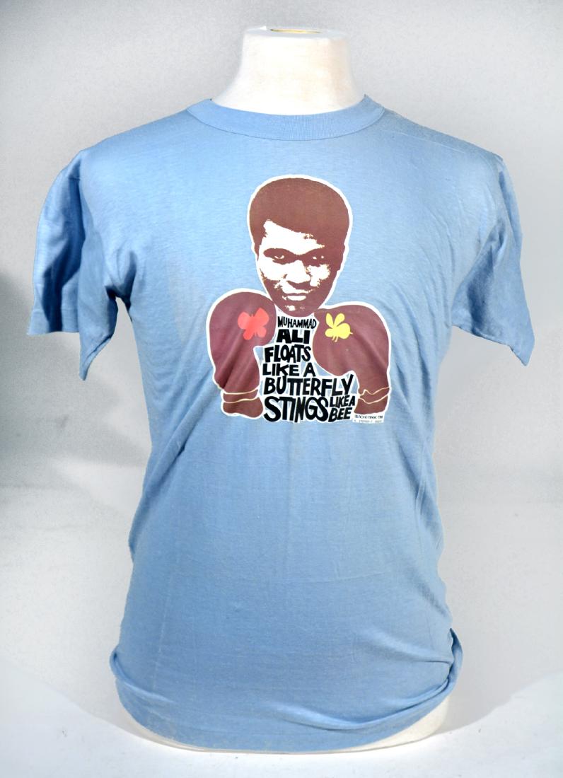 The Muhammad Ali / Bundini Brown Collection: Many described Drew "Bundini" Brown as Muhammad Ali's guru. Bundini was a friend, advisor and corner man to the Champ throughout Ali's long career. When Bundini died, he left a collection of t-shirts,