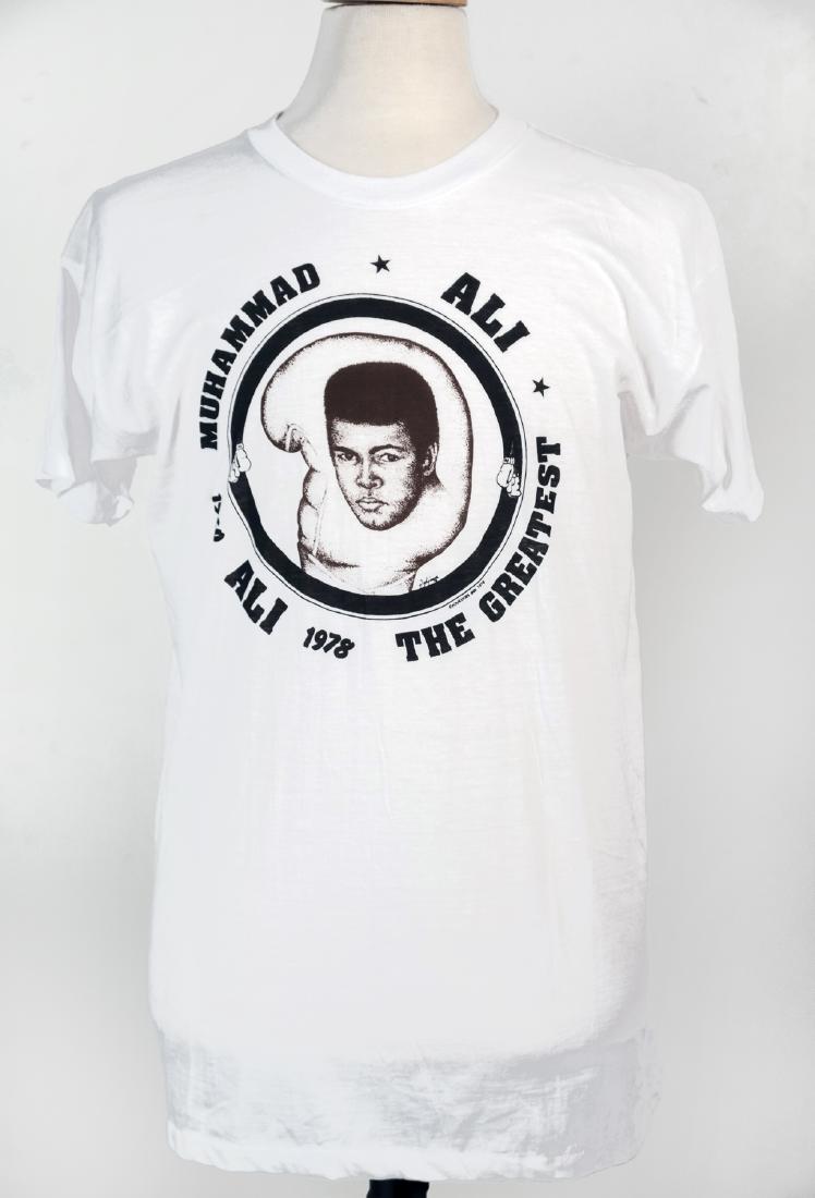 The Muhammad Ali / Bundini Brown Collection: Many described Drew "Bundini" Brown as Muhammad Ali's guru. Bundini was a friend, advisor and corner man to the Champ throughout Ali's long career. When Bundini died, he left a collection of t-shirts,