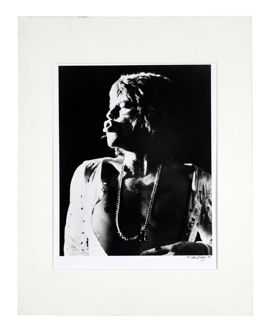 Mick Jagger Photograph by Roberto Rabanne: On stage black / white photograph of Jagger by noted photographer Michael Zagaris. Signed by the photographer and dated '72. Image size: 16"x 13" on larger paper. This is an unreserved auction with no