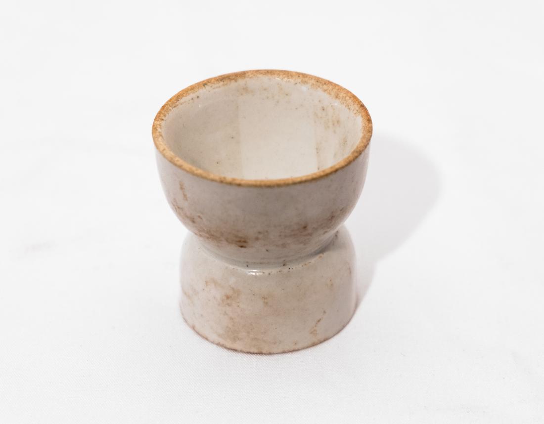 RMS Republic Egg Cup. White Star Line.: White china, 2.25"tall. Conservation Technology Group label crumpled but complete and legible. Built in 1903 by Harlan and Wolff in Belfast (the same builder which built the Titanic), White Star Lines