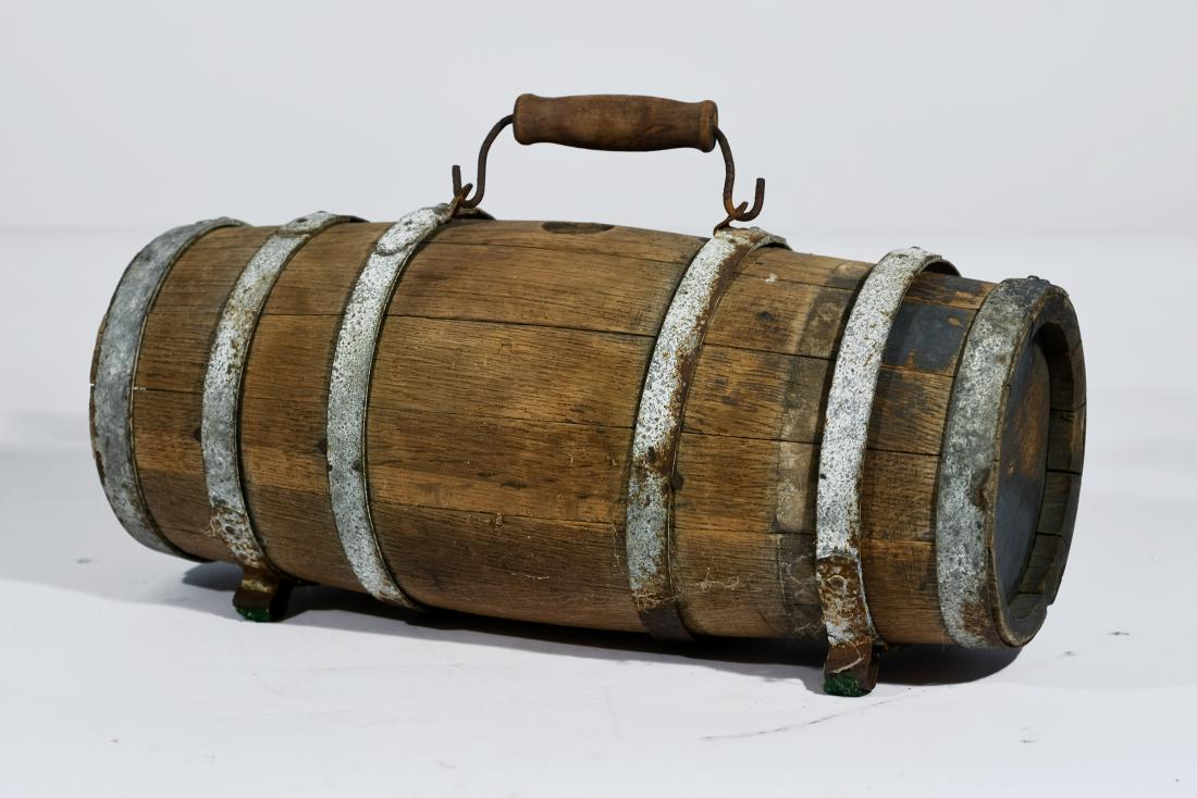 Oak Lifeboat Water Keg: A keg circa the early 1900s, banded with rings of galvenized steel, some of which are loose, and a Brass spigot. It measures 20" long and is 7 1/2" diameter on both ends, most likely used for water on