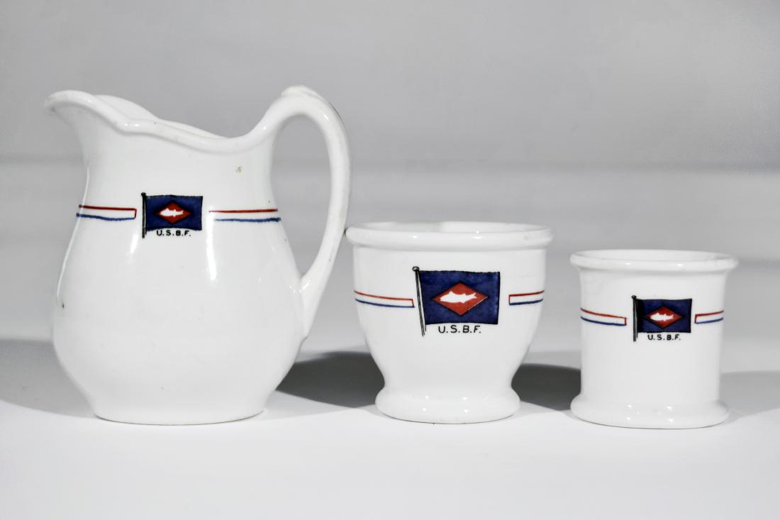 United States Board of Fisheries Table China: A hand-painted creamer (5.5" tall), a sugar pot, and an egg cup, all manufactured for the United States Board of Fisheries (and bearing the board's logo with red and white striped decoration) by Buffa