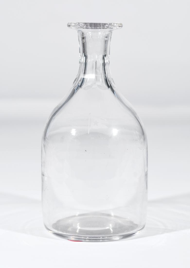 White Star Line Carafe: White Star Line carafe, circa 1890. The White Star Line flag is etched into the glass with some minor, shallow abrasions. Fluted neck. Dimensions: 9" tall This lot is from the collection originally as