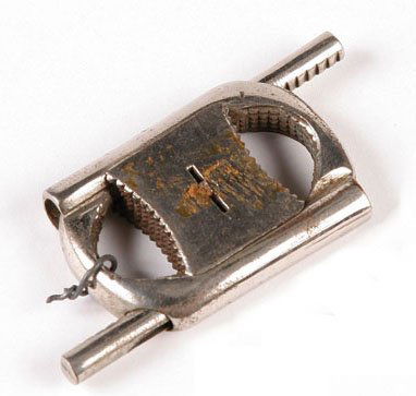 Houdini Thumb Cuffs: Small pair of metal thumb cuffs used by Harry Houdini. With a sliding lock mechanism to hold the prisoner's thumbs together. 3" Sale History: Butterfield & Butterfield, November 1999