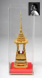 Southeast Asian Temple Gilt Model, ex. Michael Jackson: Southeast Asian Temple Gilt Model, ex. Michael Jackson. 29" x 9" x 9" (61 x 23 x 23 cm), southeast Asian gilt metal model of a temple with colored, beaded accents in a plexiglass case. As "The King