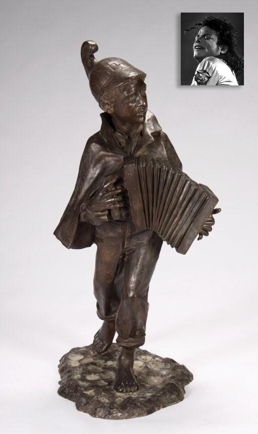 Caped Musician, Bronze, ex. Michael Jackson: Caped Musician, Bronze, ex. Michael Jackson. Sculptor: T. de Matteis, 20th Century, 48" x 67" (123 x 172 cm), variegated patinated bronze statue featuring a caped and helmeted young boy playing the ac