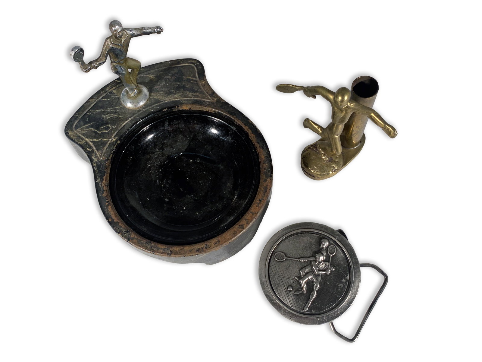 Dynamic Vintage Tennis Collectibles: Vintage Tennis Collectibles Lot consists of a tennis ashtray with black glass insert C. 1930, a bronze modernist figure of a tennis player C. 1920, and a pewter belt buckle created as a limited editio