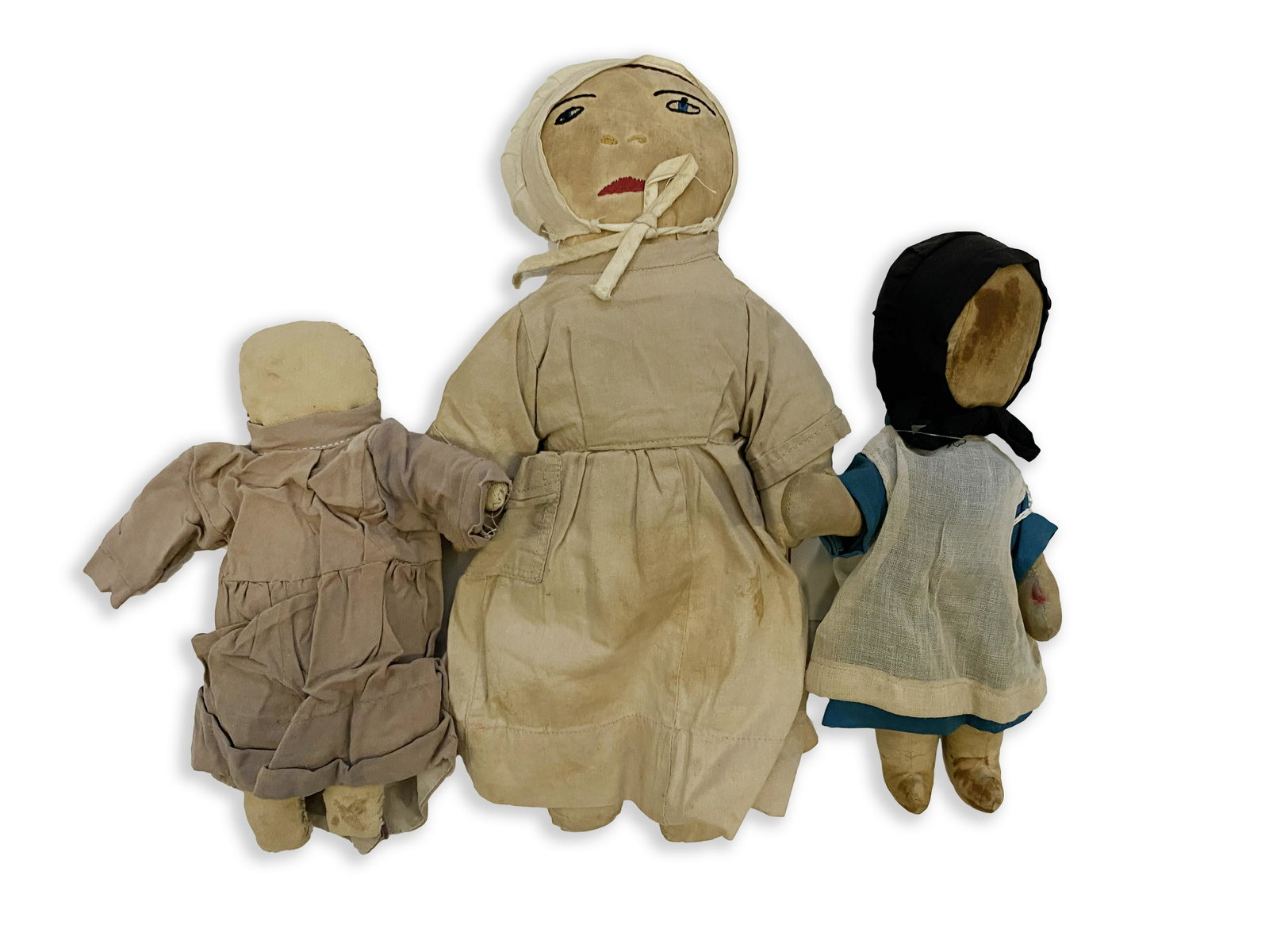 Three Antique Female Amish Dolls: Three Antique Female Amish Dolls C. 1900 Doll with black bonnet, two piece blue dress with white apron, no face, 9" long. Children's doll with light brown dress. Canvas body with grey stitching on top