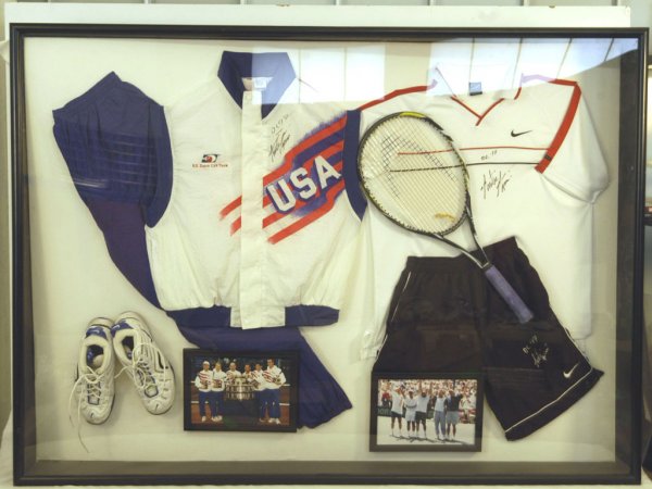 Andre Agassi 1997 Davis Cup Collection Display: Andre Aggasi's Davis Cup collection from the 1997 Davis Cup Team: An autographed warmup, shirt, shorts, shoes and racquet, originally purchased at the Aggasi Foundation Fund Raiser in Las Vegas. In a 