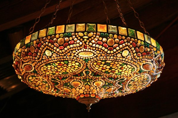 Art Nouveau-Style Tiffany Glass Hanging Lamp: Art Nouveau-style leaded glass ceiling lamp crafted from Tiffany workshop glass, including square frogs' back jewels, opalescent glass, and marbleized glass. With oval cartouches, white daisy-like flo