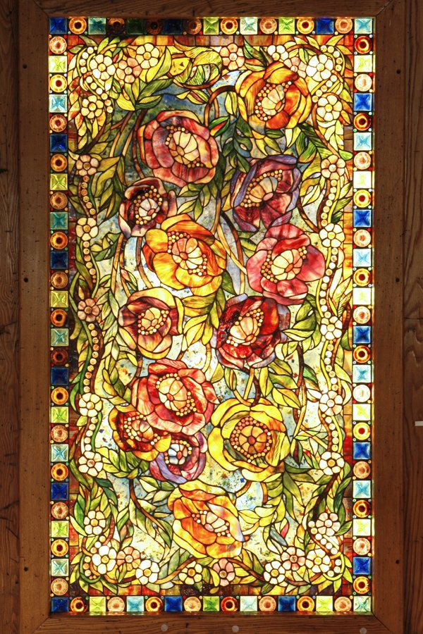 Tiffany Leaded Glass Panel with Floral Motif: One of two leaded glass panels in the Rafters Room crafted entirely from Tiffany workshop glass, the oversized figurative floral motif features distinctive Tiffany glass features such as mottled and "