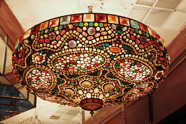 Art Nouveau-Style Tiffany Glass Hanging Lamp: Created in the early 1970's for the soon-to-be-opened Tavern on the Green, this circular Art Nouveau-style leaded glass ceiling lamp is crafted from Tiffany workshop glass, including square frogs' bac
