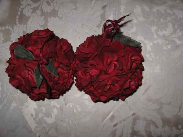 Faux Rose Balls: Faux roses made out of red fabric with a ribbon for hanging. 27 small and 20 large.