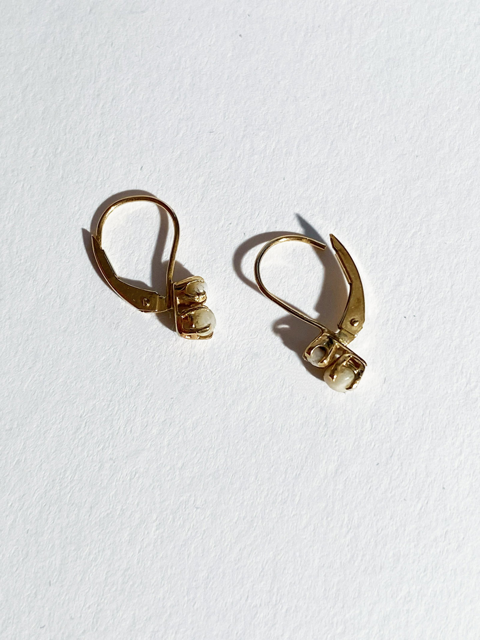 Pair of Pearl Earrings - 4 Pearls Recovered from The Santa Margarita: A pair of earrings with a gold setting containing 4 pearls recovered from The Santa Margarita. On June 10th, 2007 the crew of the vessel Blue Water Rose, while working on the site of the Santa Margari