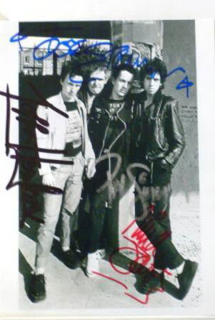 Clash Signed Pennie Smith Photograph "the Clash",: A Pennie Smith silver gelatin print. Signed on the print by all four members of The Clash including Joe Strummer, Mick Jones, Paul Simon and Terry Chimes. Provenance: Pennie Smith Collection. 10 x 6 i