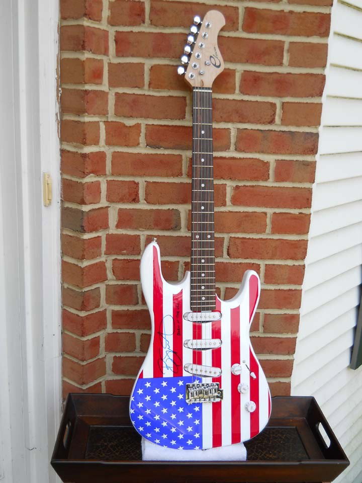 Bruce Springsteen Signed Red, White, & Blue Elect: Red, white, and blue electric guitar is signed by Bruce Springsteen. It includes a certificate of authenticity.