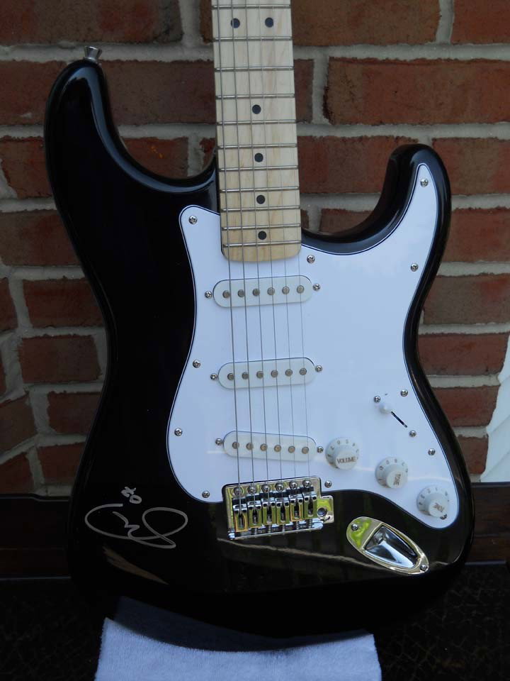 Eric Clapton Signed Black Fender Guitar: A black Fender guitar signed by Eric Clapton at his Crossroads Festival. Includes a certfiicate of authenticity.